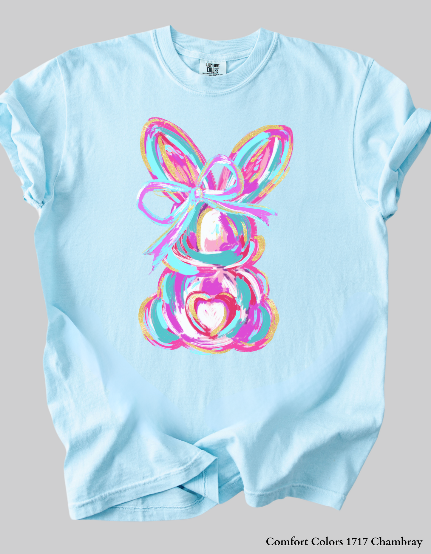lat lay of the Color Splash Bunny Easter Collection, featuring cozy T-Shirts and Sweatshirts in pastel spring shades with a festive bunny design.