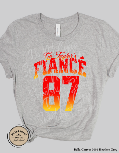 Go Taylor’s Fiancé 87 Football Tee – Red & Gold Game Day Shirt (Adult Sizes)