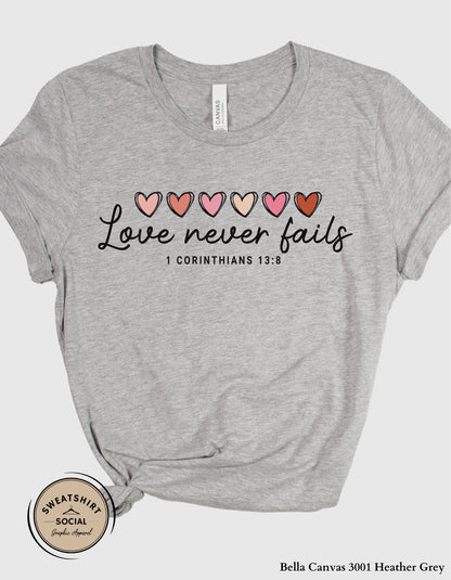 Love Never Fails Valentine Shirt – 1 Corinthians 13:8 Heart Design (Adult Sizes S–2XL)