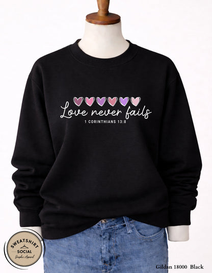 Love Never Fails White Valentine Shirt – 1 Corinthians 13:8 Heart Design (Adult Sizes S–2XL)